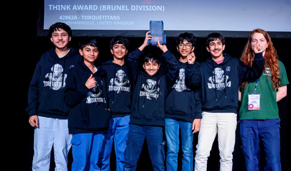Team on stage with the Think Award trophy