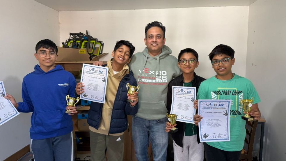 Students holding certificates and trophies