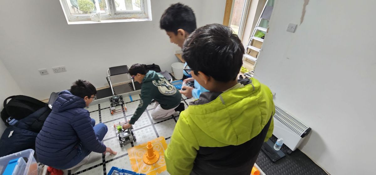 Students building and practicing with their robot