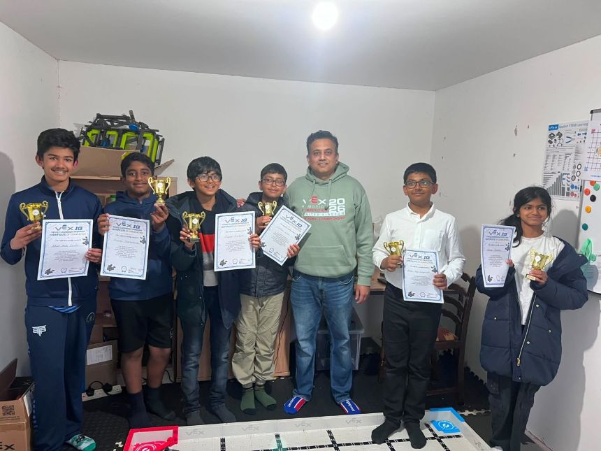 Students holding certificates and trophies
